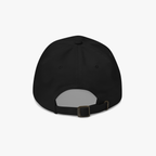 The back view of a black baseball cap with an adjustable strap and metal buckle, shown on a light gray background.
