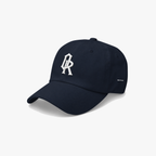 Navy blue classic cap with a white embroidered 'OR' logo on the front, set against a plain light gray background.