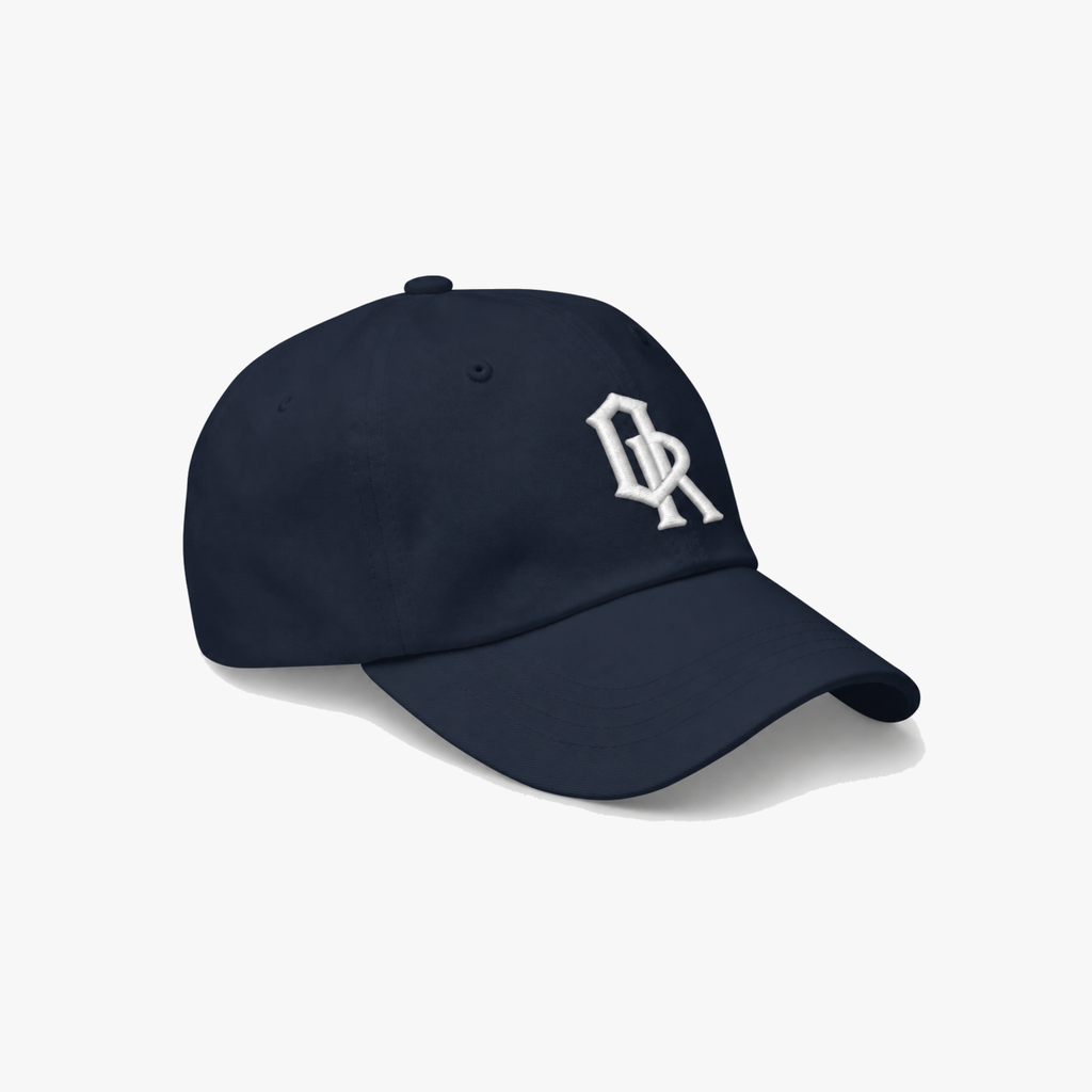 Navy blue classic cap with a white embroidered 'OR' logo on the front, set against a plain light gray background.