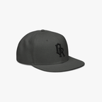 Charcoal grey snapback cap with a black embroidered 'OR' logo on the front, set against a plain light gray background.