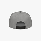 The back view of a light gray snapback cap with a black adjustable strap and ventilation eyelets, shown on a clean white background.