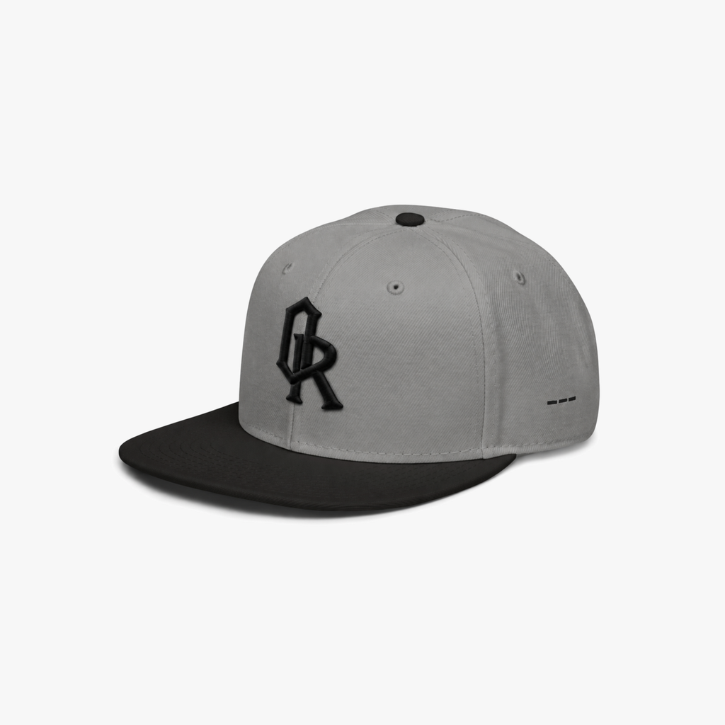 Grey and black snapback cap with a black embroidered 'OR' logo on the front, set against a plain light gray background.