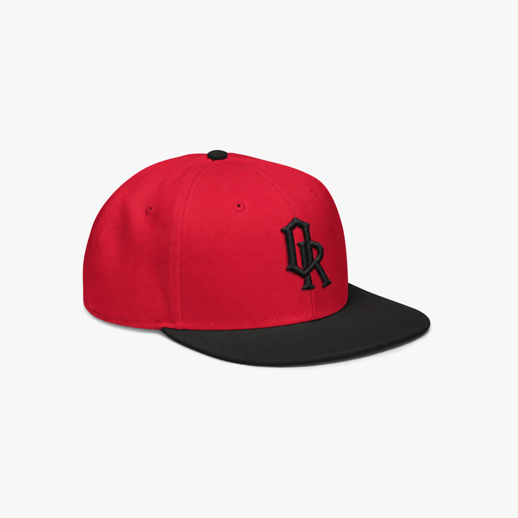 A red and black snapback cap with a black embroidered 'OR' logo on the front, set against a plain light gray background.