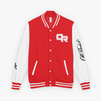 A red and white varsity jacket with a red front panel, white sleeves, white ribbed trim, and white buttons. The chest features a white 'OR' monogram, and the right sleeve has a black script signature reading 'Preston'.