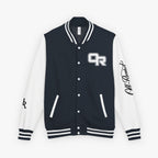 A black and white varsity jacket with a black and white striped ribbed collar, cuffs, and hem. The front has a black body with white buttons, a white 'OR' logo on the left chest, and a black script logo on the right sleeve.