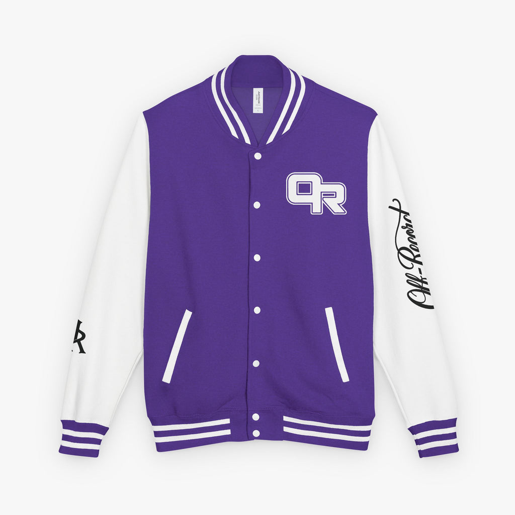 A purple and white varsity jacket with a purple front panel, white sleeves, and a purple and white 'OR' logo on the left chest. It features white ribbed trim on the collar, cuffs, and hem, and a black script signature on the right sleeve.